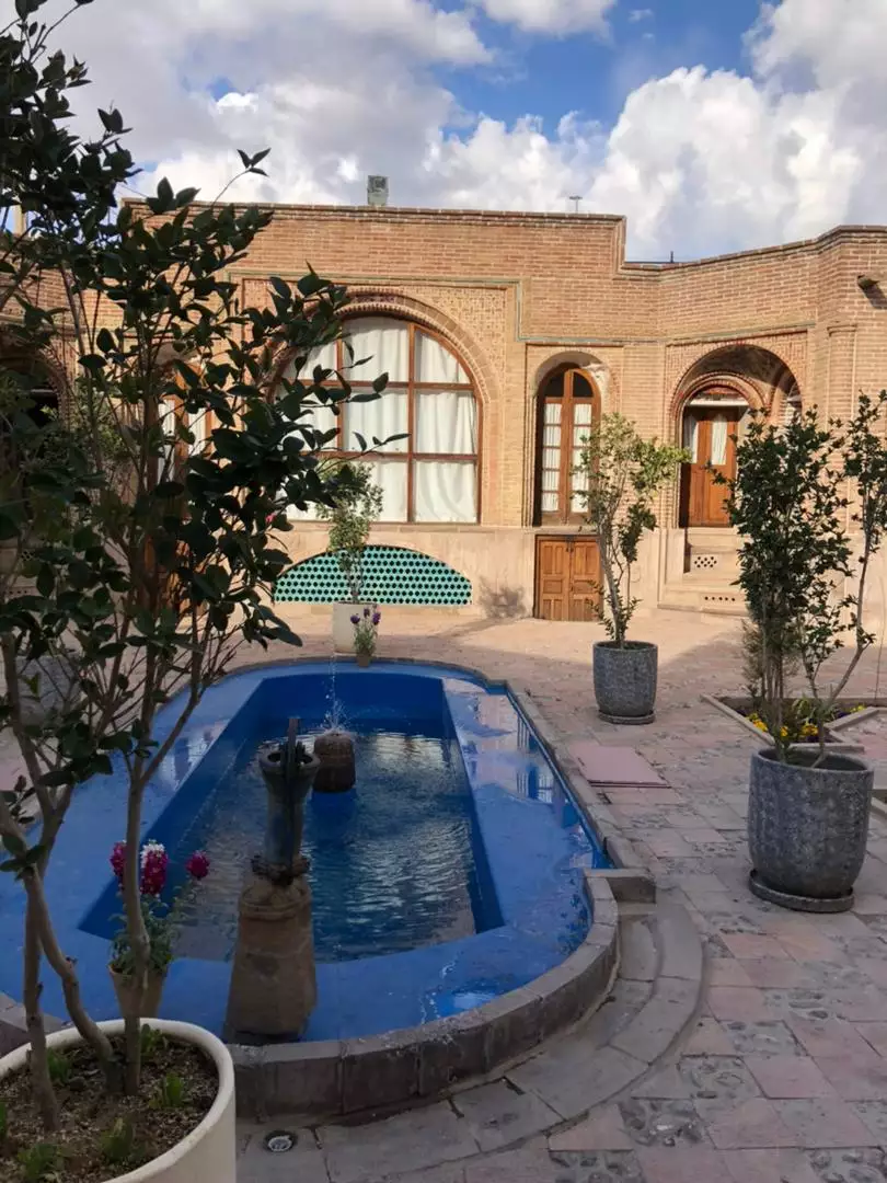 حوض آبی و نمای آجری حیاط هتل ارغوان قزوین