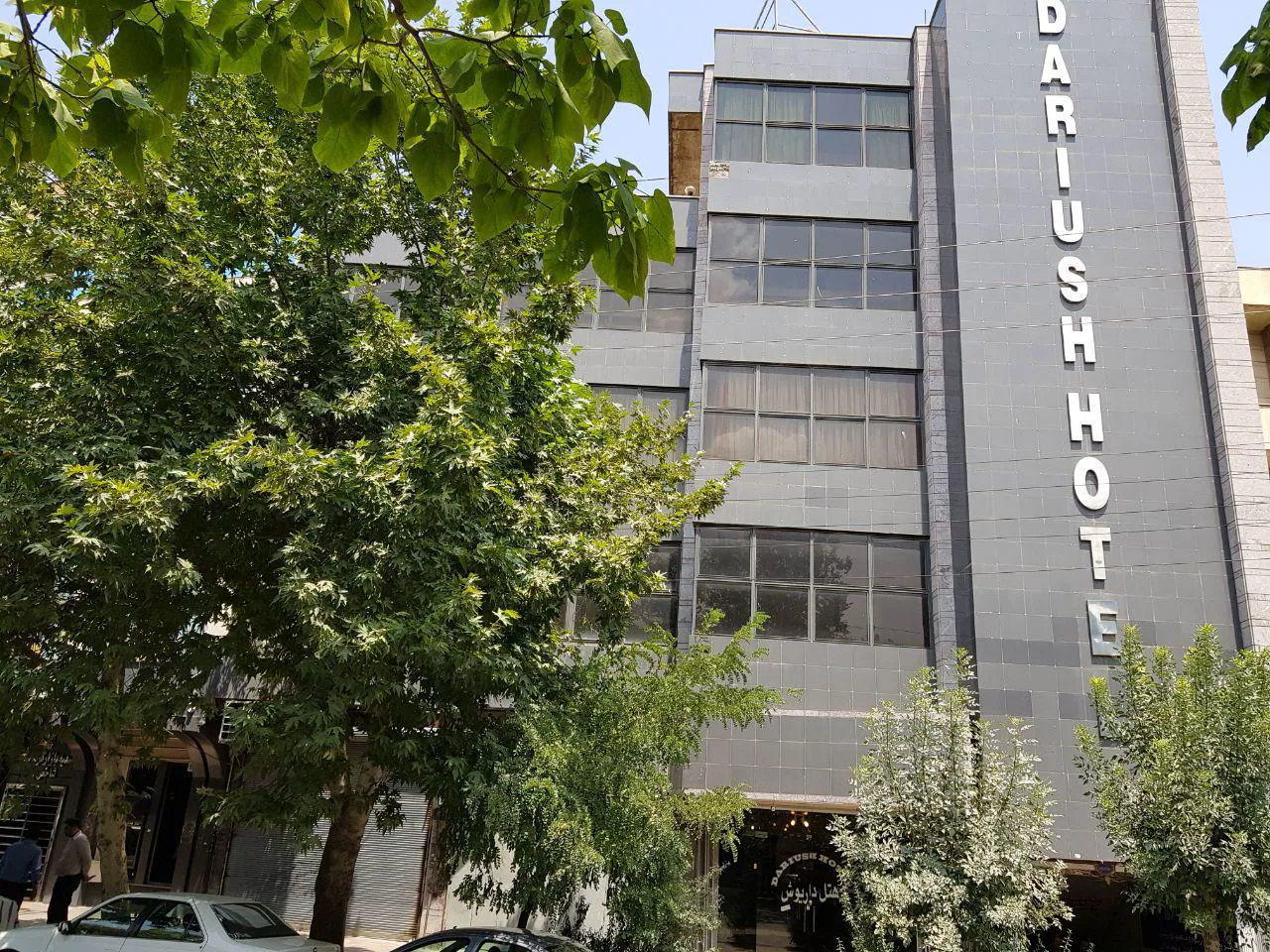 نمای بیرونی ساختمان هتل داریوش میان درختان