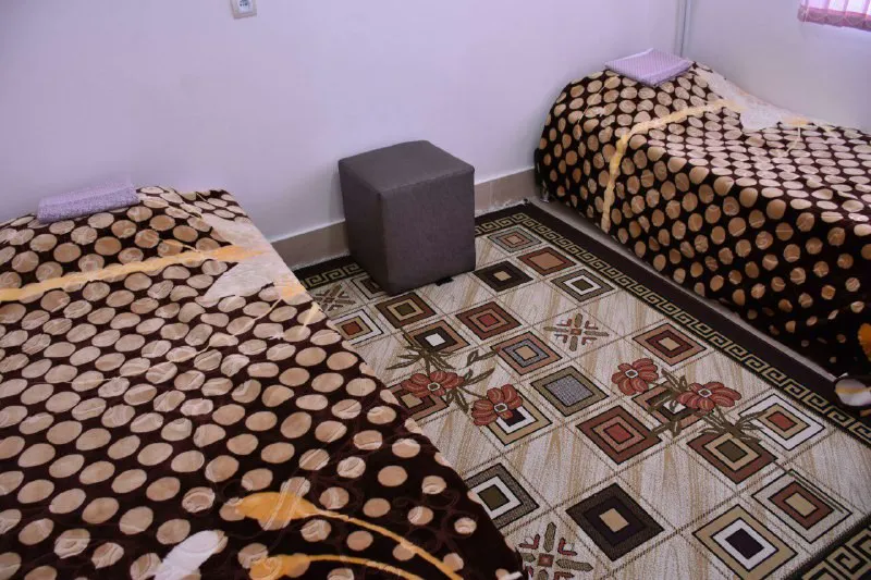 اتاق هتل آتا با دو تخت و روتختی طرحدار