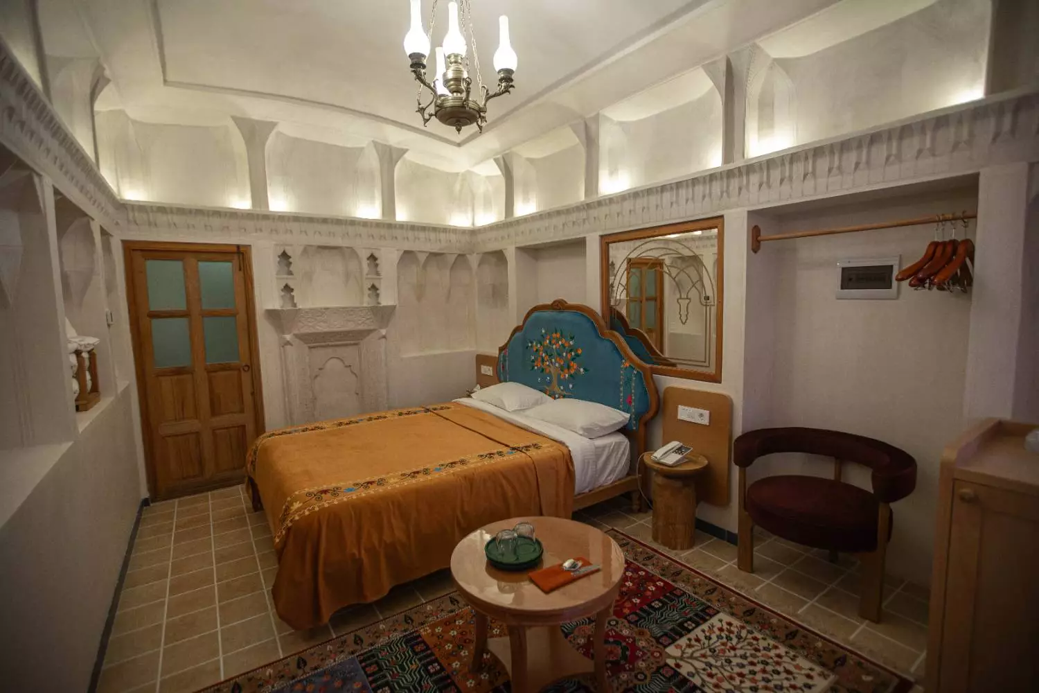 اتاق عمارت آقاحسینی با تخت قهوهای و فرش ایرانی