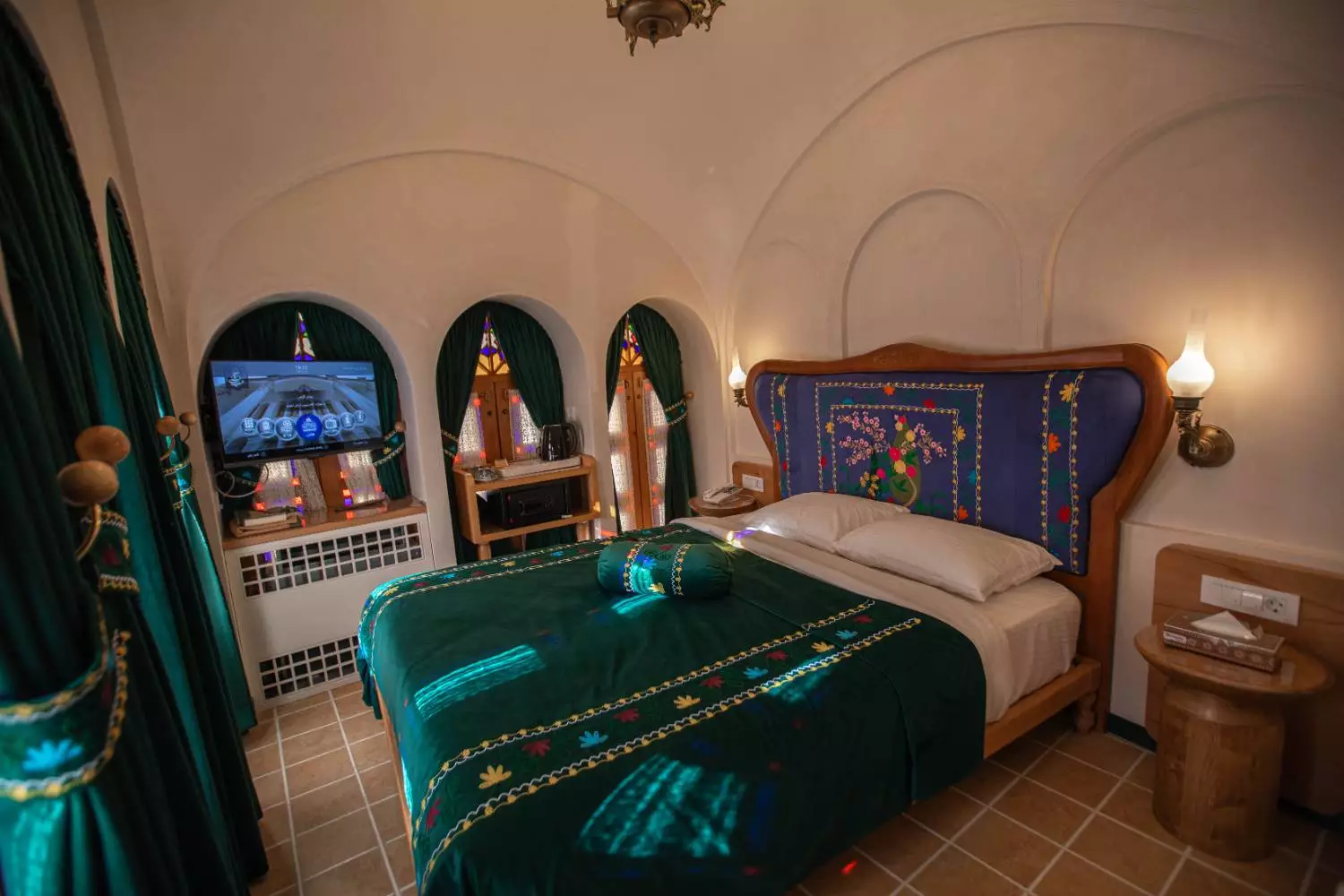 تخت خواب با روتختی سبز در عمارت آقاحسینی