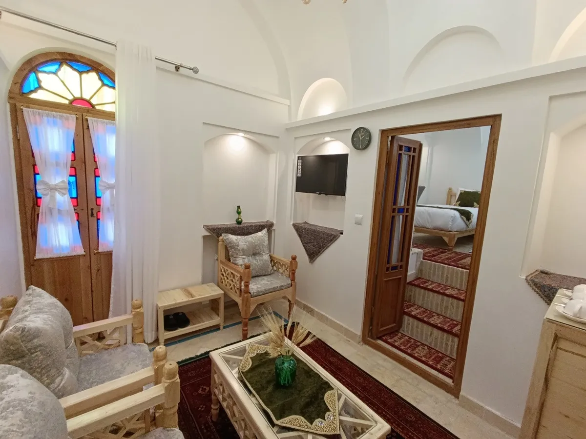 نشیمن عمارت شمسه کنار پنجره رنگی و آینه