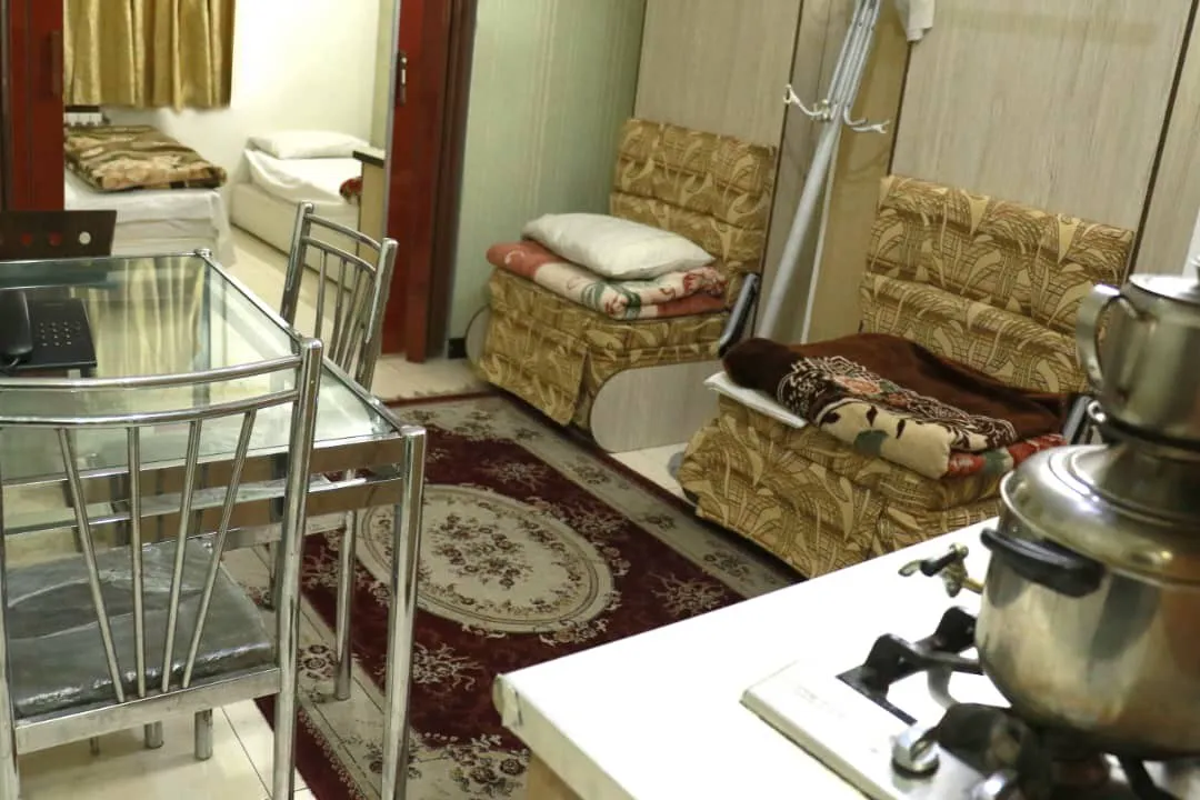 اتاق نشیمن با مبل، میز و اجاق در هتل محراب