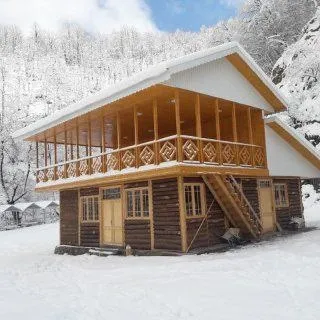 کلبه چوبی هتل آریا در میان برف