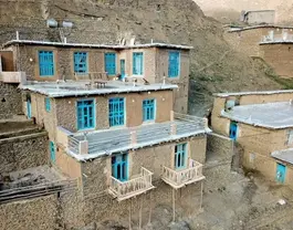 ساختمان سنگی اقامتگاه واران با پنجره‌های آبی