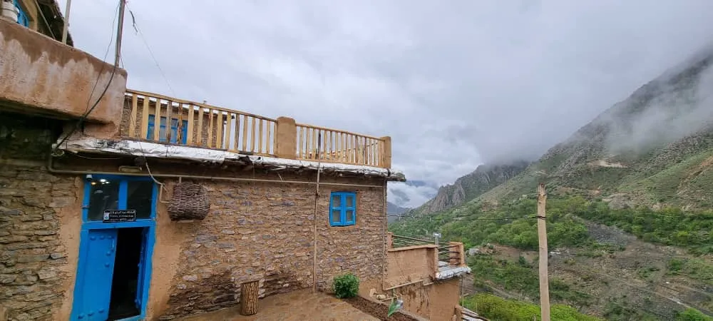 اقامتگاه واران با نمای سنگی در کوهستان مه‌آلود