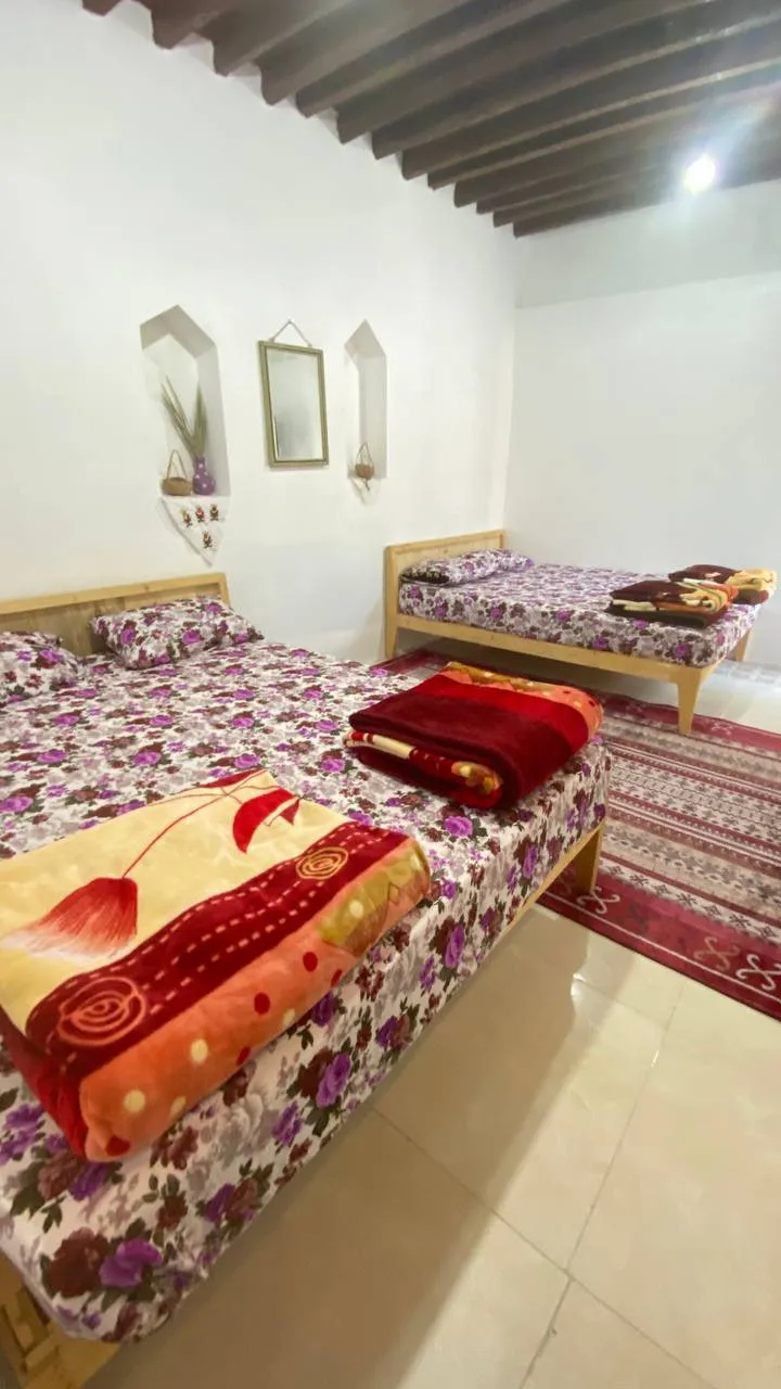 اتاق کاکا با دو تخت و روتختی گل‌دار