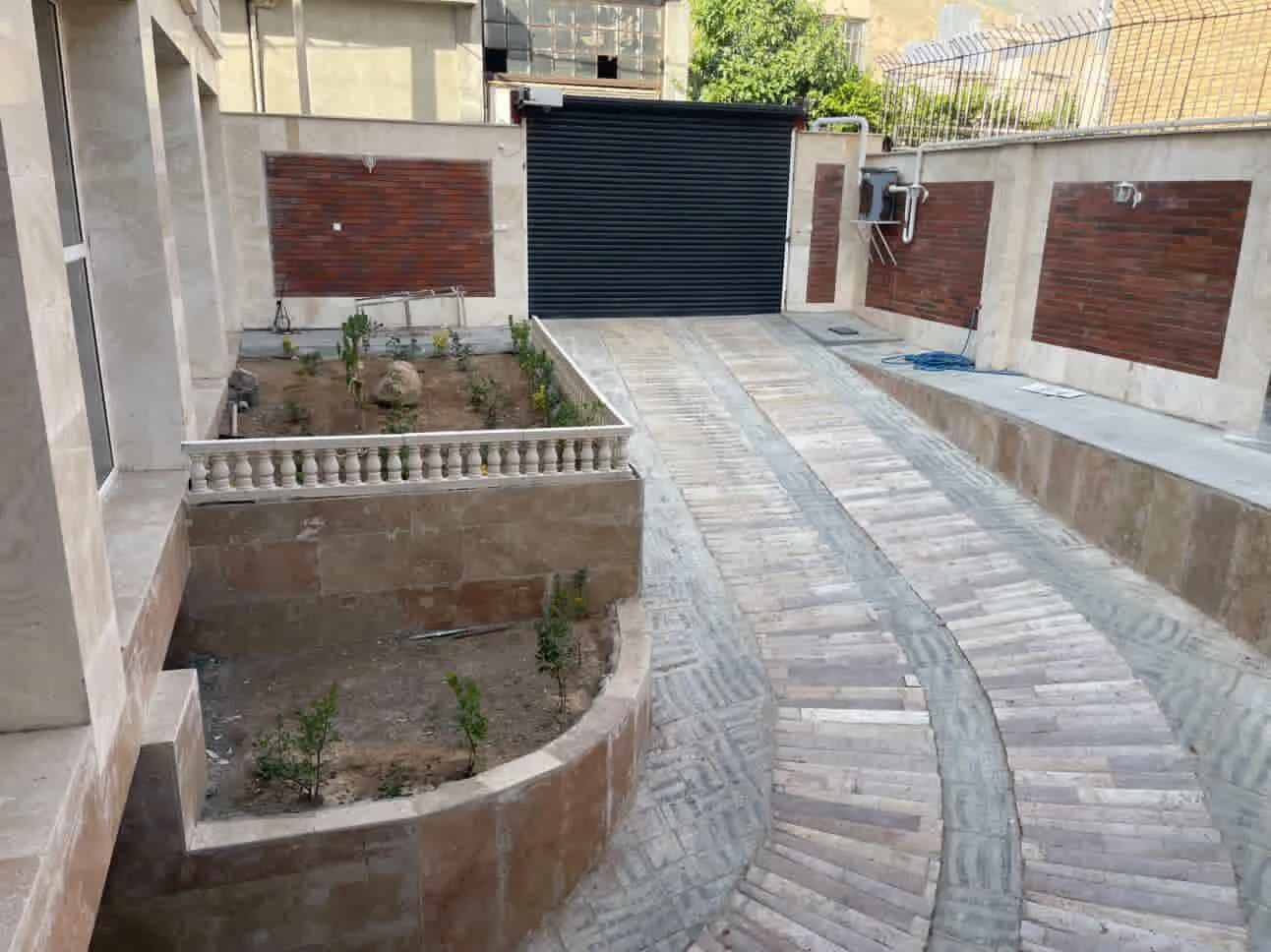 مسیر ورودی هتل معین با باغچه و دروازه