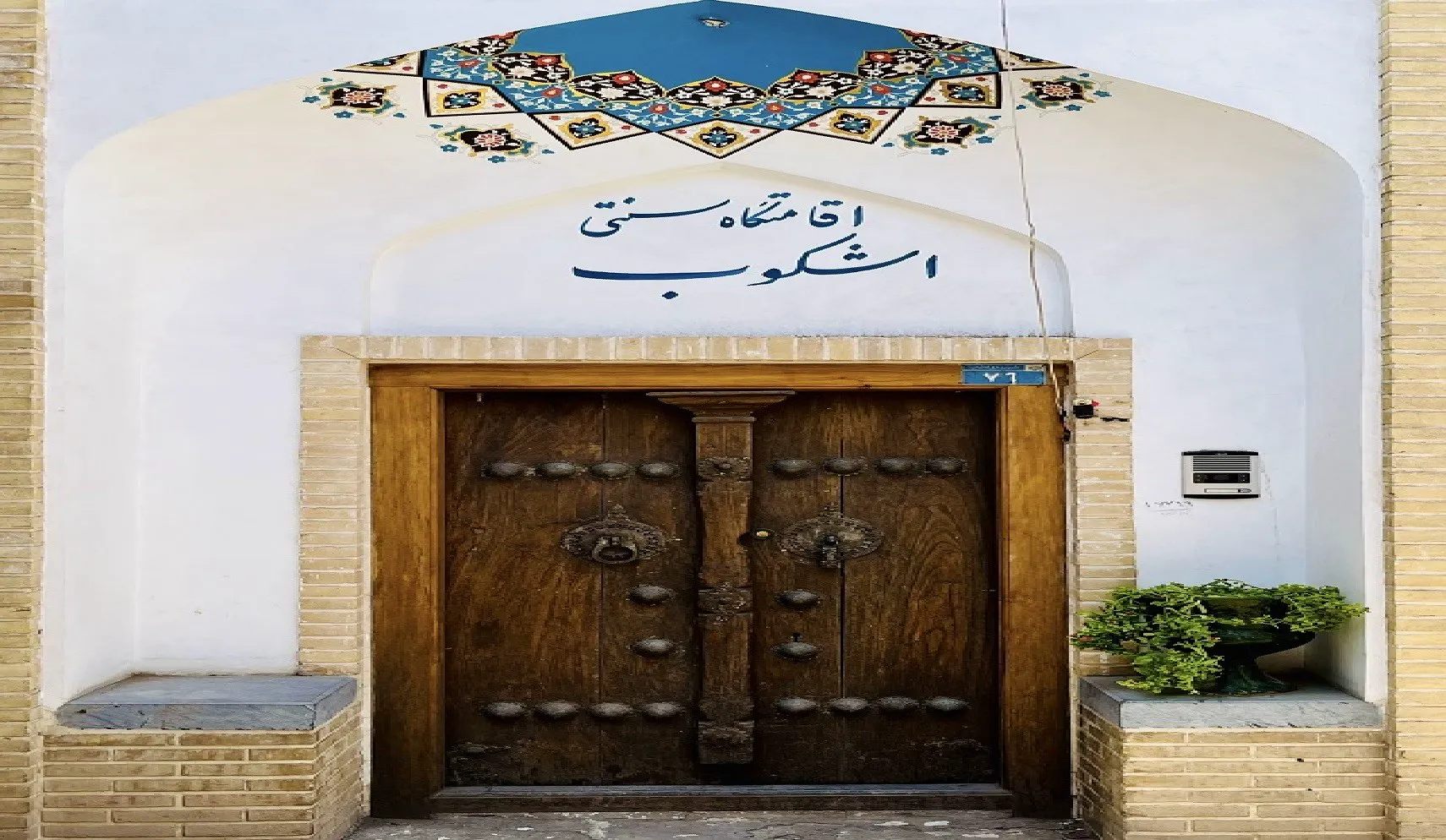 ورودی چوبی هتل اشکوب با کاشی‌کاری سنتی