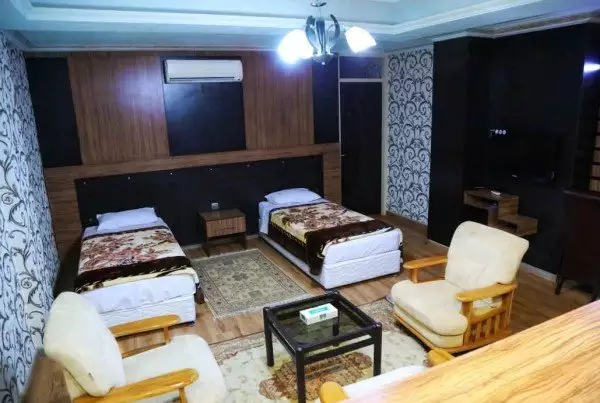 اتاق هتل هدیه با دو تخت یک‌نفره و مبلمان نشیمن