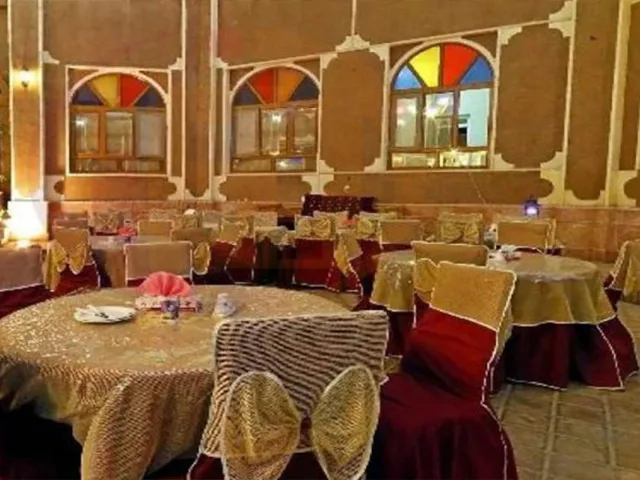 سالن پذیرایی سنتی عماد نظام با میزهای گرد