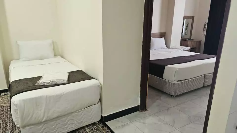 دو تخت یک‌نفره در اتاق هتل آنا