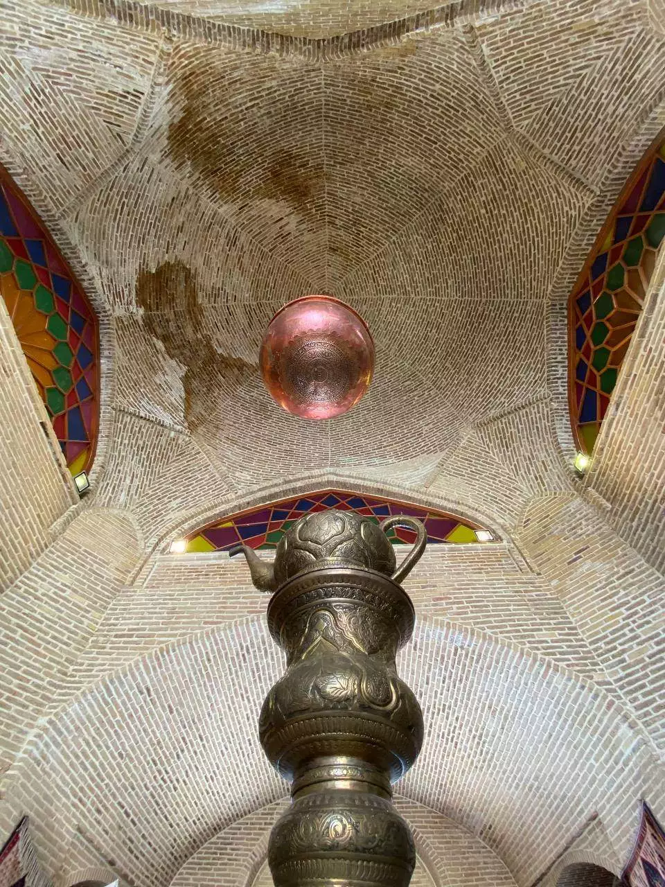 نمای نزدیک کوزه فلزی زیر سقف آجری لاله بیستون