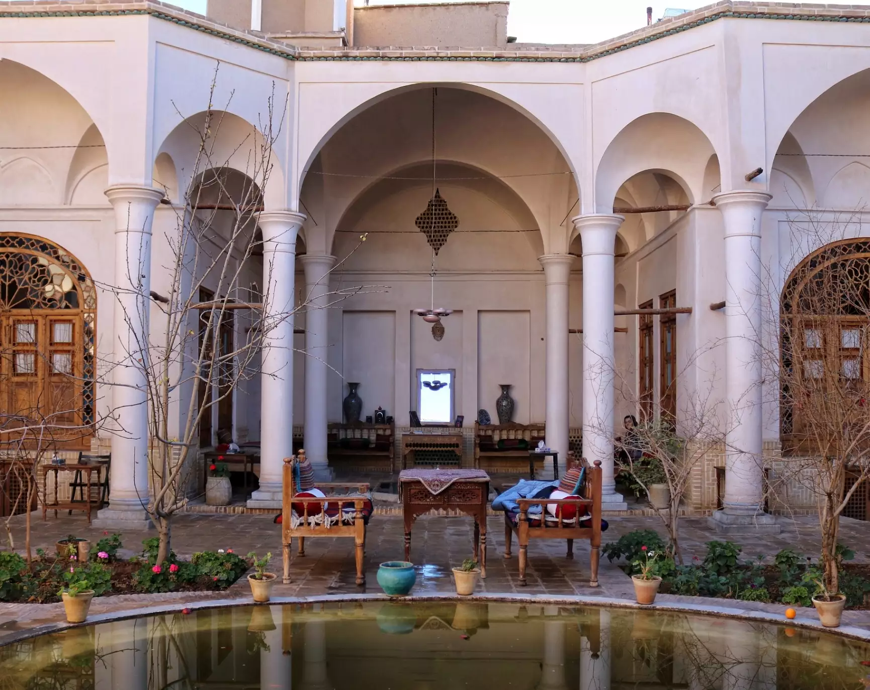 حیاط خانه مرشدی با حوض و ایوان قوسی