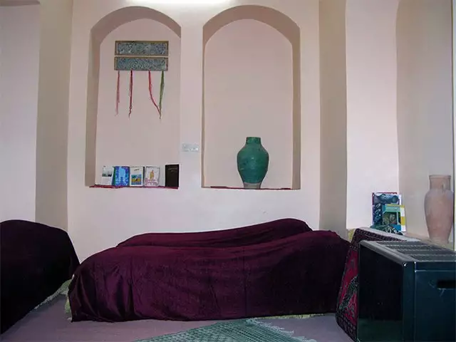 فضای خواب خانه نقلی با رختخواب و طاقچههای دیواری