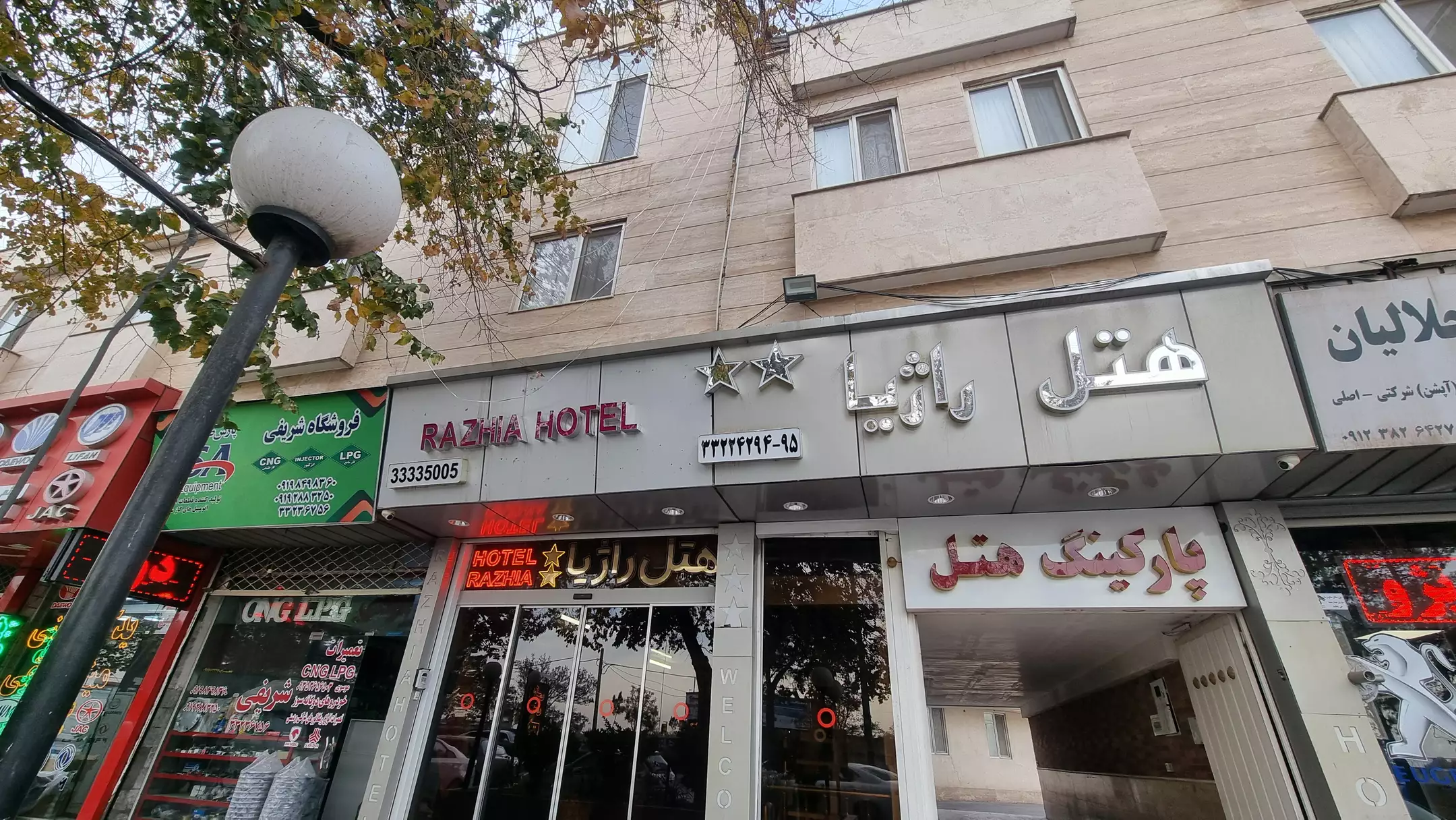 نمای ورودی هتل راژیا با تابلوهای چندزبانه