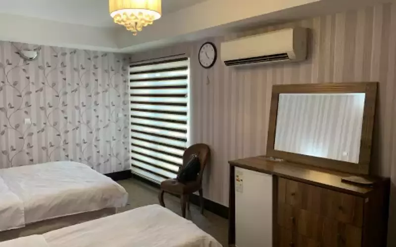 اتاق آذین با دو تخت و میز آرایش