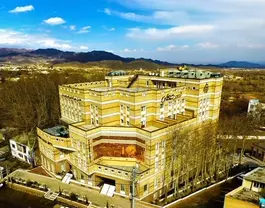 نمای هوایی هتل قصرجهان میان درختان و کوهستان