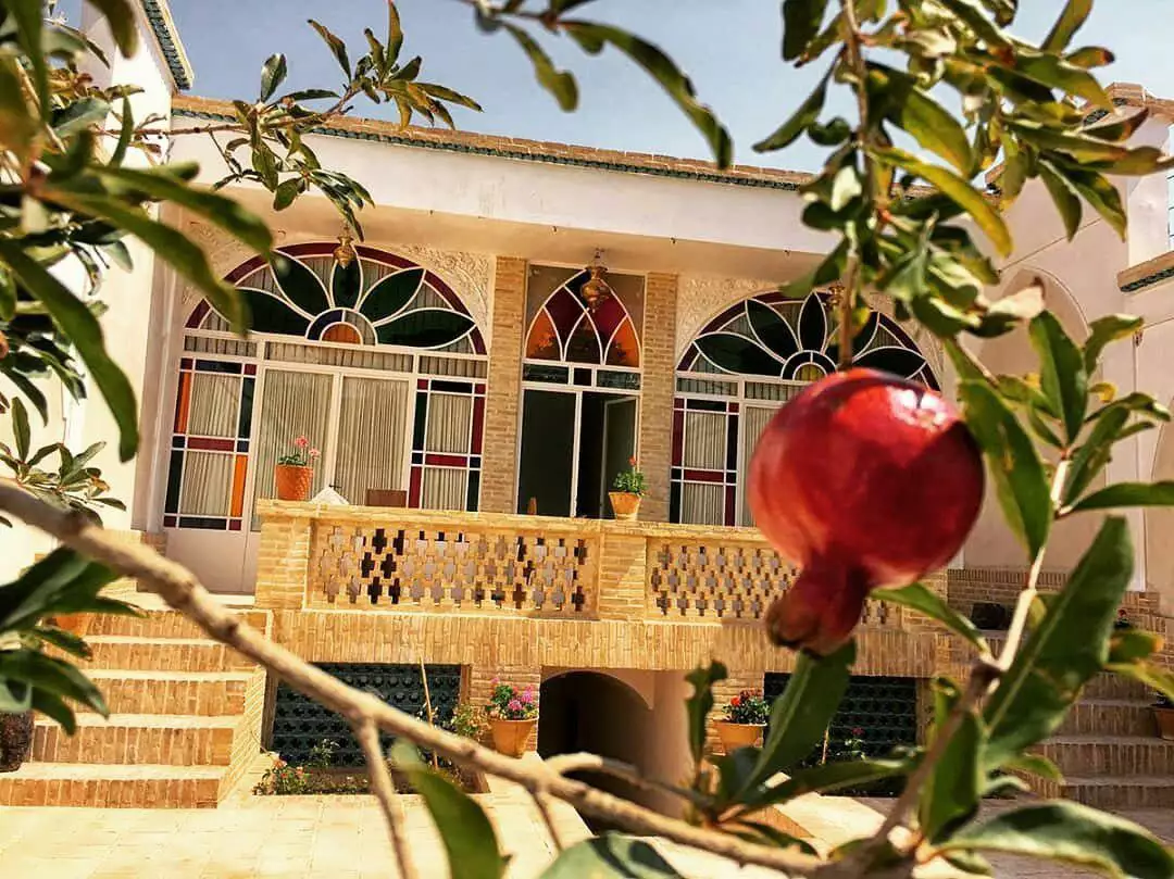 نمای سرای ملک از پشت شاخه انار