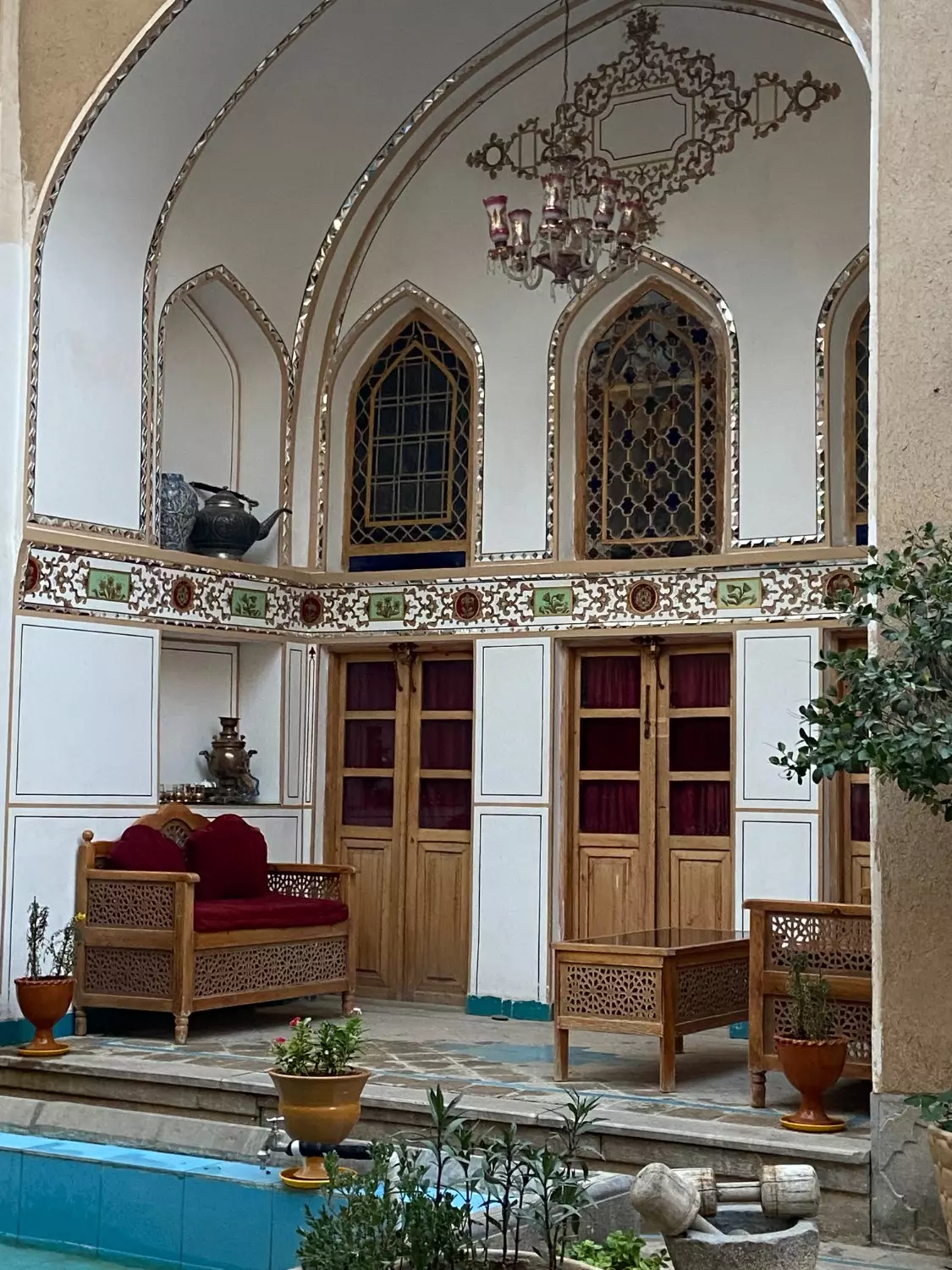 ایوان سنتی هتل یاس با پنجرههای قوسی و مبلمان چوبی