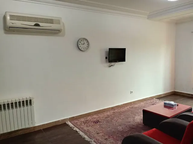 نشیمن هتل ساینا با تلویزیون دیواری و فرش
