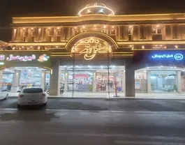 نمای شبانه ورودی ساختمان رستم با نورپردازی طلایی
